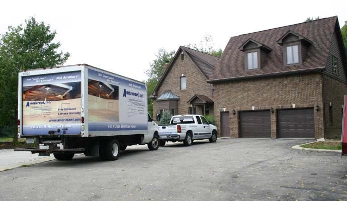 Americrawl service truck parked at a residential property