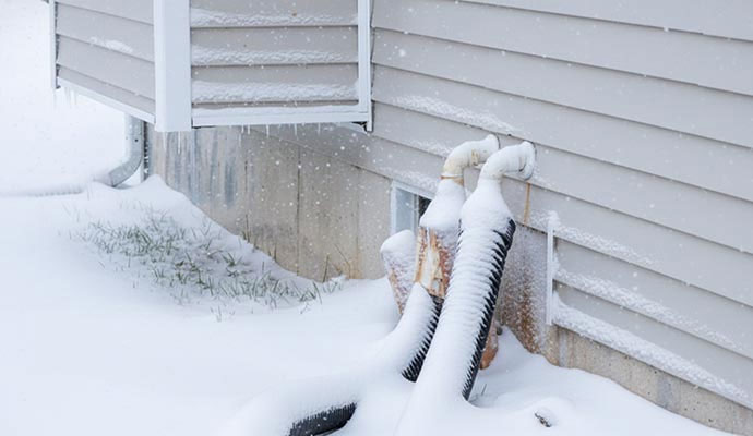 Frozen discharge line on house exterior