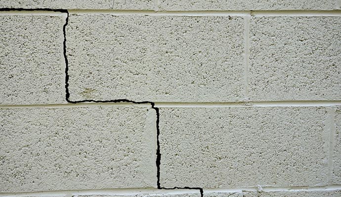 Close up view of visible crack on basement wall