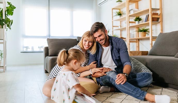 Happy family enjoying improved air in home Happy family enjoying improved air in home