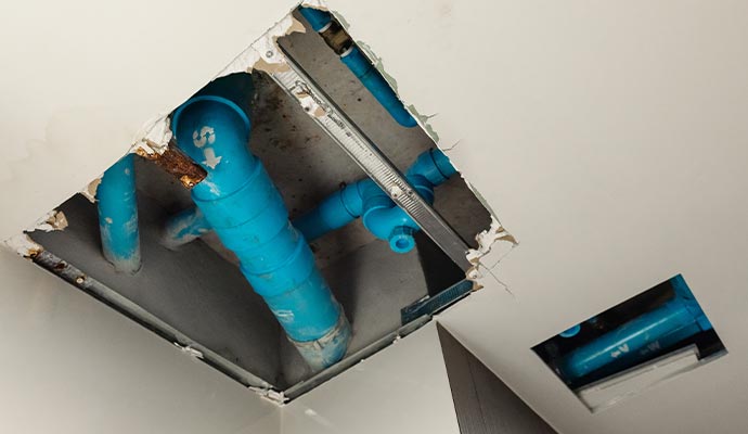 collapsed drain in restroom water leak out from waste piping system