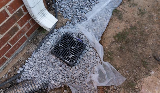 installed under a downspout to alleviate drainage red brick home