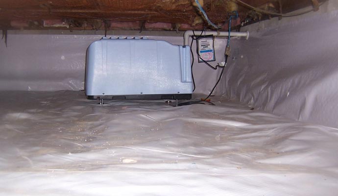 Light blue dehumidifier on a white crawl space vapor barrier Light blue dehumidifier on a white crawl space vapor barrier