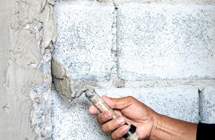 Repairing damaged walls through shearing for restoration.