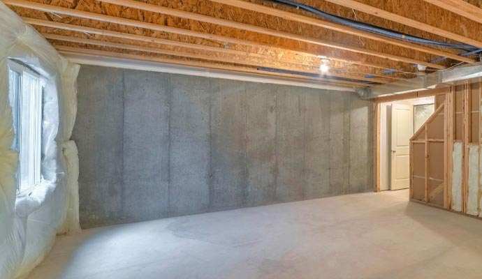 Unfinished basement with concrete walls and clean floor