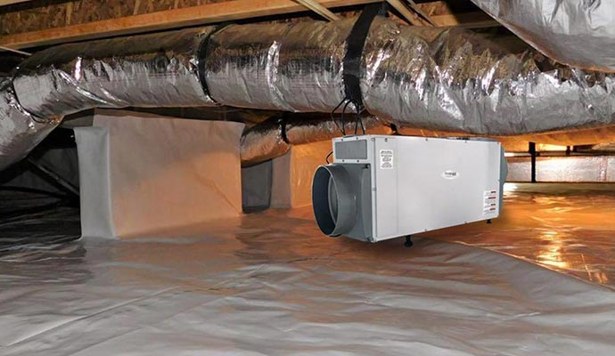 White dehumidifier hanging in an encapsulated crawl space
