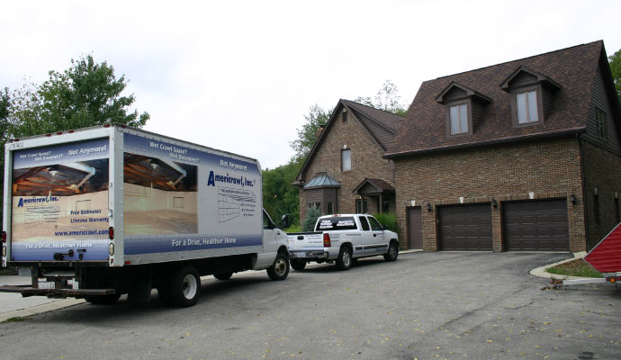 Americrawl service vehicle standing in front of a house